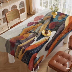 May include: A rectangular tablecloth with a colourful abstract design featuring trees, leaves, and mountains. The tablecloth is made of a soft, durable fabric and is perfect for adding a touch of modern art to your dining room.