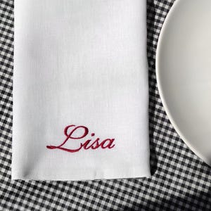 Elevate your table setting with these elegant custom linen napkins, embroidered with names in a refined script. Perfect for weddings, dinner parties, and special occasions, they add a personal touch to any gathering. Made from premium linen, they make a sophisticated wedding or housewarming gift. Customize with your chosen name and thread color for a unique, timeless look!