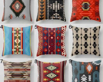 May include: Nine decorative throw pillows with Southwestern geometric patterns. Pillows feature various color schemes including red, black, blue, and beige. Designs include arrows, diamonds, and tribal motifs, suitable for home decor.