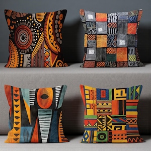 Puede incluir: Cuatro cojines decorativos con patrones geométricos vibrantes en tonos naranja, negro, azul y amarillo. Los cojines presentan diseños abstractos con influencias tribales y étnicas, agregando un toque de estilo cultural a la decoración del hogar.