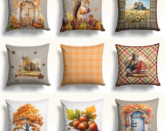 May include: Nine different throw pillow designs featuring autumnal themes. The pillows feature images of squirrels, acorns, farmhouses, and fall foliage. The pillows are all rectangular and have a variety of colors and patterns.