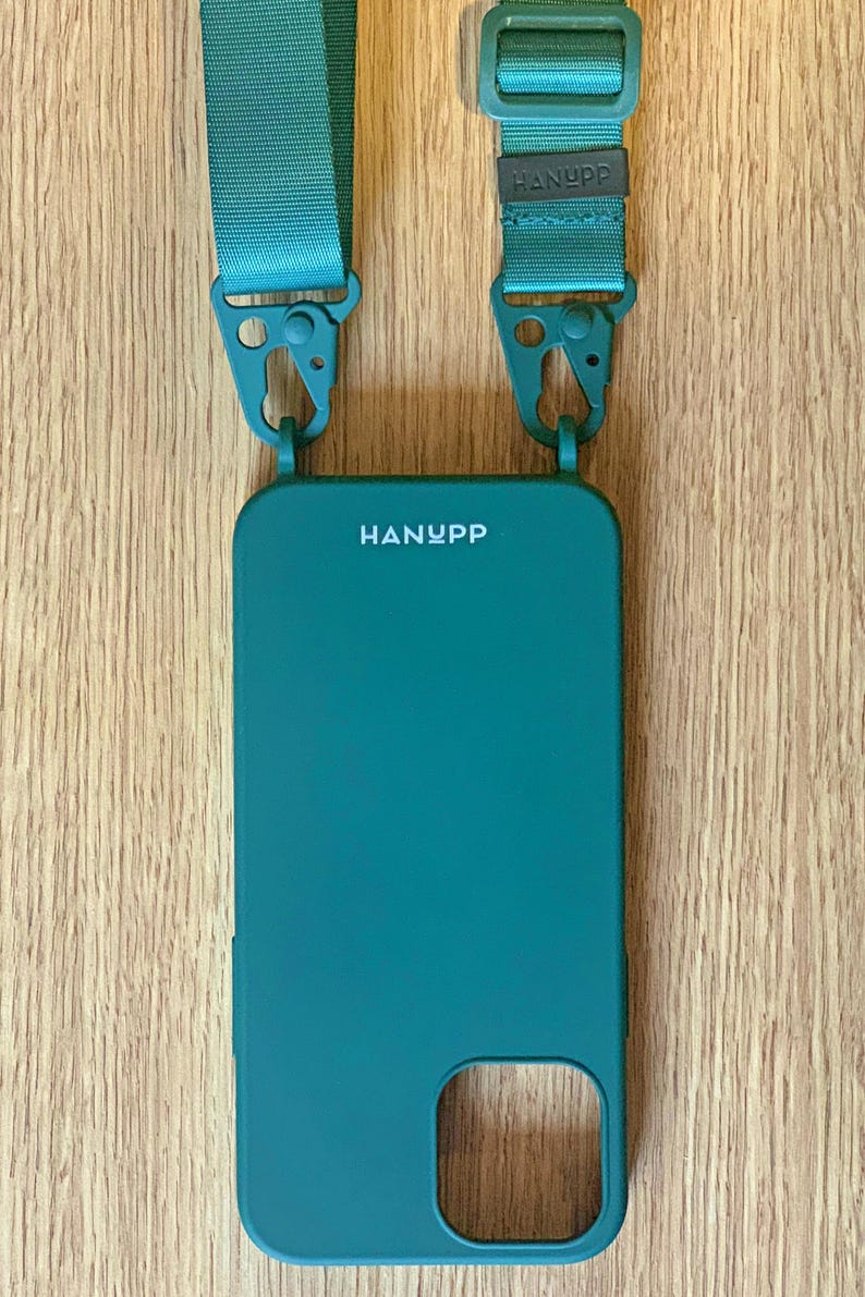 May include: Teal phone case with a matching teal strap. The phone case has the brand name "HANYPP" printed on it. The strap has the brand name "HANYPP" printed on the strap. The strap is attached to the phone case with teal metal clasps.