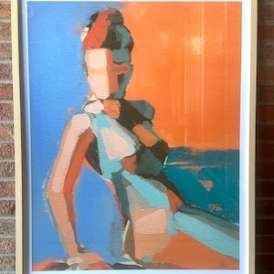 May include: Abstract painting in a wooden frame. The artwork features a figure with a blue, orange, and teal color palette. The figure is depicted with broad brushstrokes, creating a modern and artistic aesthetic.
