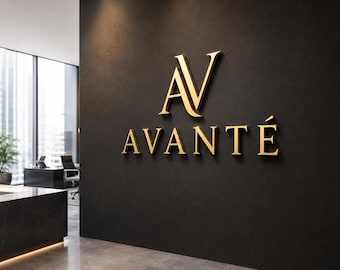 Pode incluir: Logotipo "AVANTÉ" dourado fixado em uma parede escura. O logotipo apresenta um símbolo "AV" estilizado acima da palavra "AVANTÉ" em uma fonte serifada. O cenário parece ser um interior de escritório ou empresa.