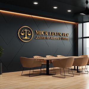 3D logo wall sign made with polished or brushed metal for a custom lobby sign in stainless metal on a dark wall in a modern conference room.