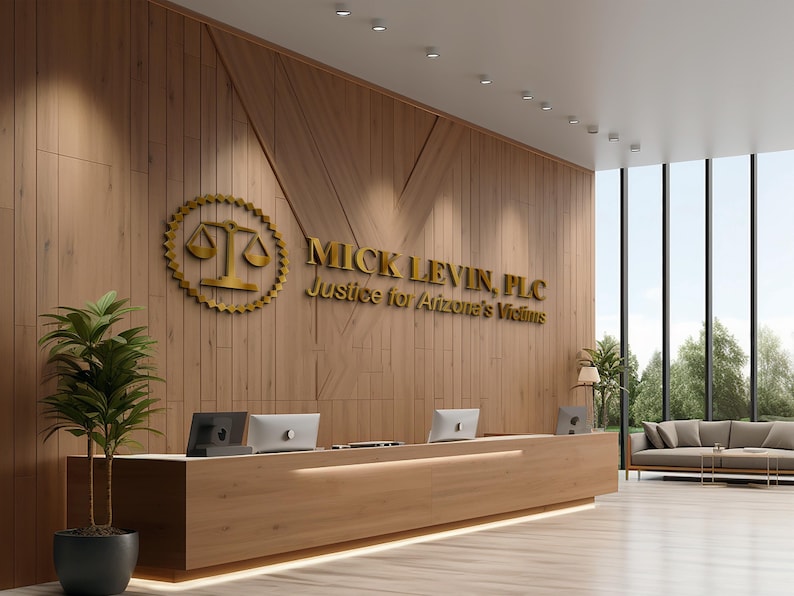 3D logo wall sign made with polished or brushed metal for a custom lobby sign in stainless metal on a dark wall in a modern conference room