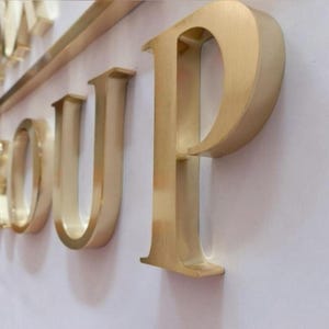 Stainless steel logos and lettering suitable for indoor and outdoor use.