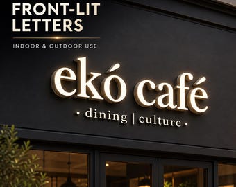 Pode incluir: Uma placa de loja preta com as palavras "ekó café" em letras iluminadas personalizadas com iluminação frontal. A placa também inclui o texto "dining | culture" e "INDOOR & OUTDOOR USE".