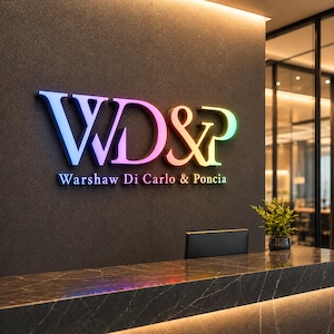 May include: A wall-mounted sign featuring the large, illuminated letters WD&P in a gradient of blue, purple, orange, and green. Below the letters, the text Warshaw Di Carlo & Poncia is displayed in a smaller, matching gradient font on a dark wall.