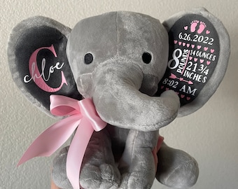 May include: Gray plush elephant with a pink bow, personalized with the name "Chloe" and birth details: 6.26.2022, 8 pounds 1 3/4 ounces, 21 3/4 inches, 8:02 AM.