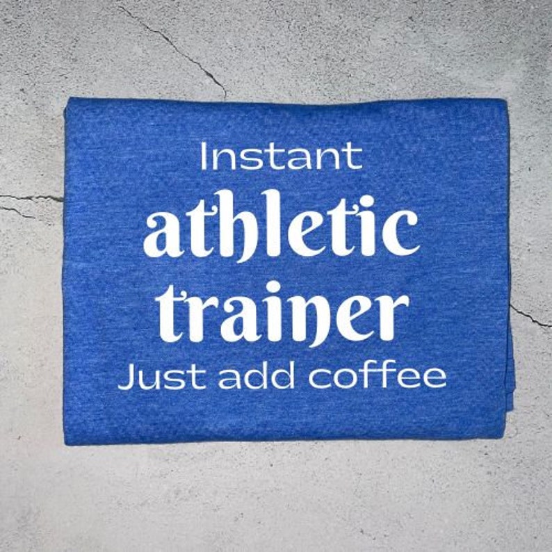 May include: Blue t-shirt with white text that reads "Instant athletic trainer. Just add coffee."