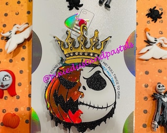 May include: A black and white Jack Skellington face with a pumpkin on the left side. The face is wearing a gold crown with rhinestones. The image is on a holographic background with the text "POPGRIP" at the bottom.