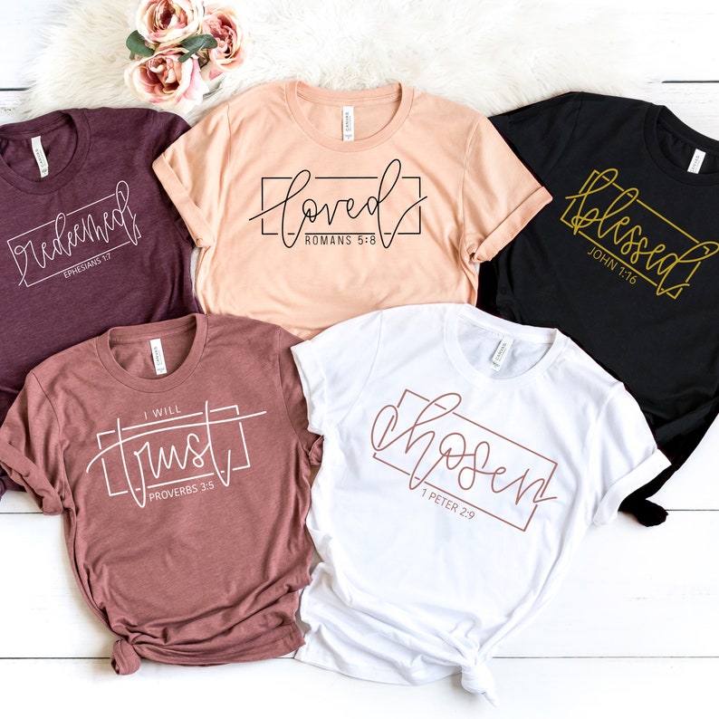 May include: Five different t-shirts with various bible verses printed on them. The shirts are in different colors, including maroon, peach, white, and black.