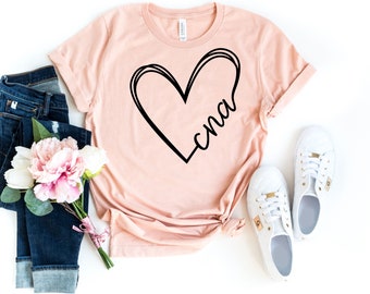 May include: A peach-colored t-shirt with a black outline of a heart and the word "cna" inside the heart.