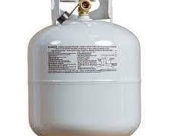 May include: A white propane gas cylinder with a brass valve and pressure gauge. The tank has a cylindrical body and a rounded top. It is designed for outdoor use, such as barbecuing or camping. The tank is sitting on a white base.
