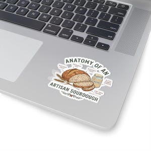May include: A sticker featuring a diagram titled Anatomy of an Artisan Sourdough, showing a loaf of bread, slices, wheat stalks, and a jar of starter with labels pointing to features like blistered crust, prominent ear, and airy open crumb.