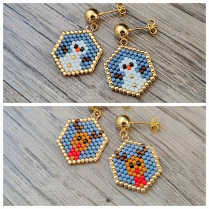 May include: A pair of gold dangle earrings with blue and white beaded hexagons featuring a snowman and a reindeer design.