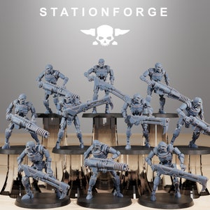 May include: A group of nine gray plastic robot figures, each holding a weapon, standing on circular bases. The robots are posed in a variety of action poses. The background is a gray wall with the text "STATIONFORGE" in white letters.