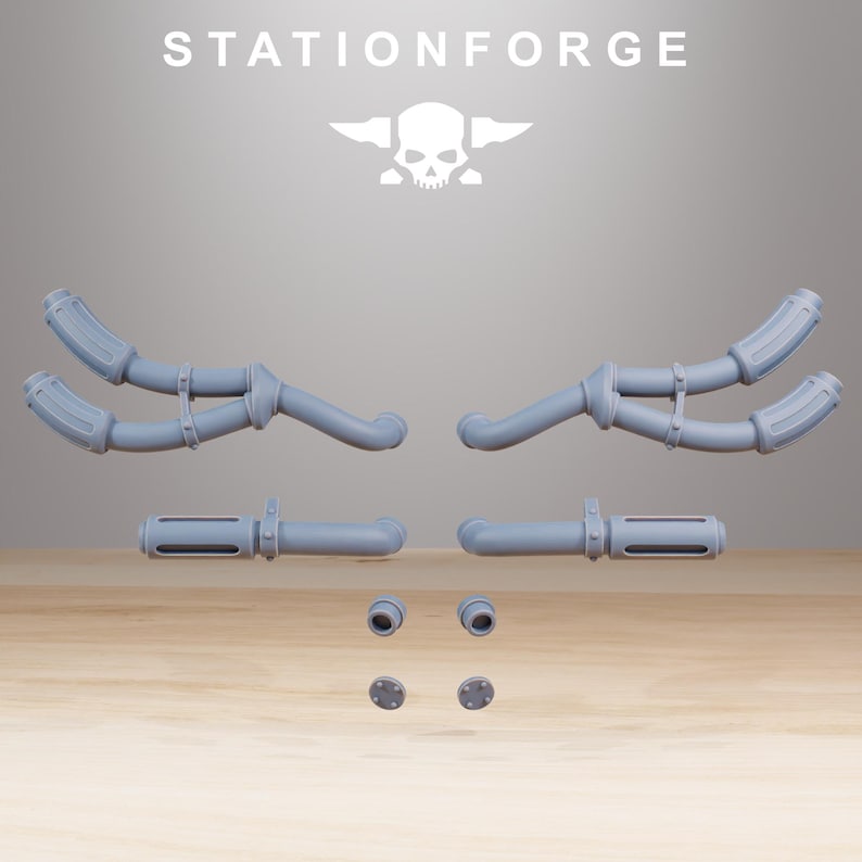 May include: A collection of light gray, 3D-printed components, including curved pipes, cylindrical pieces, and small circular parts. The text "STATIONFORGE" is displayed above a skull logo. The parts are arranged on a wooden surface.