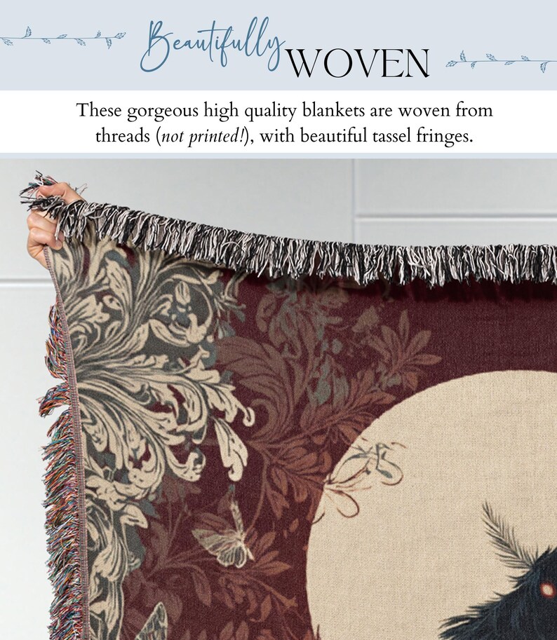 May include: A woven blanket with a dark red background and a cream-colored moon design. The blanket features a floral pattern in shades of gray and cream, with a black and white tassel fringe. The text "Beautifully WOVEN" is at the top.