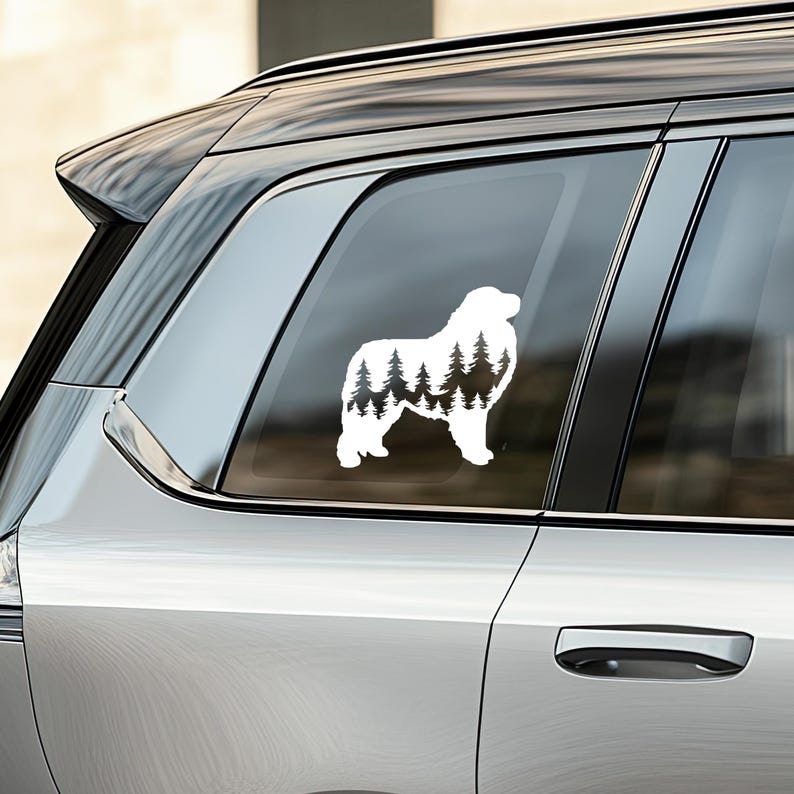 May include: White silhouette of a dog with a forest inside its shape. The dog is standing on a car window.