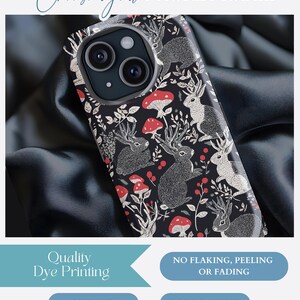 May include: A black phone case with a white and red pattern of deer and mushrooms. The case is made with quality dye printing and is vibrant and long lasting.