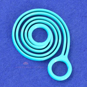 May include: A turquoise spiral-shaped object with a handle and a circular opening. The object is made of a solid material and is set against a blue background. The website address "COPPERKEEP.COM" is visible at the bottom.