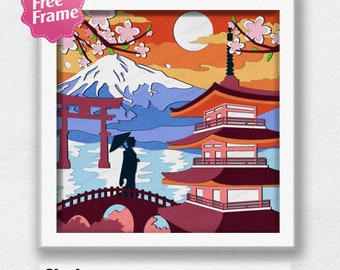 May include: A layered papercraft design featuring a Japanese pagoda, a red bridge, a mountain, and cherry blossoms. The design is in a white frame with the text "Shadow Box 14 LAYER SVG EPS DXF PDF" below the frame.