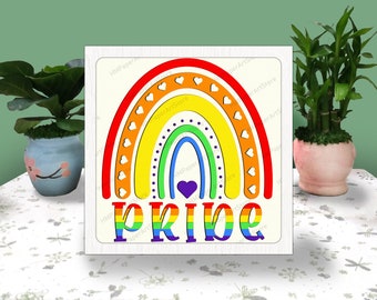 May include: A rainbow with hearts and the word "PRIDE" in rainbow colors. The rainbow is on a white background.