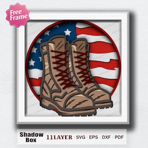 May include: A framed shadow box featuring a pair of brown combat boots with red laces, set against a backdrop of the American flag. The design is in a white frame, with text at the bottom indicating it is a 11-layer SVG, EPS, DXF, and PDF file.