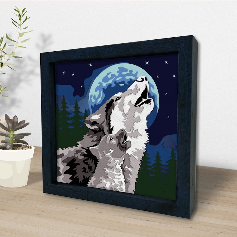 May include: A framed painting of two wolves howling at the moon. The wolves are gray and white, and the moon is a pale blue. The background is a dark blue with stars.