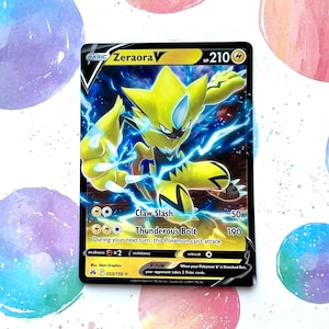 May include: A Pokemon trading card featuring Zeraora V, a yellow electric-type Pokemon with a star on its head. The card has a black border and features the text "Zeraora V" and "Claw Slash" and "Thunderous Bolt".