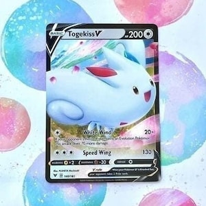 May include: Togekiss V Pokemon card featuring a light blue and pink Togekiss with a white wind attack that does 20+ damage and a speed wing attack that does 130 damage.