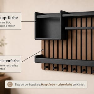 May include: A wall-mounted organizer featuring a black frame, box, shelves, and hooks attached to a vertical slat backboard. Text labels indicate color options for the frame and slats, with a note to select colors when ordering.