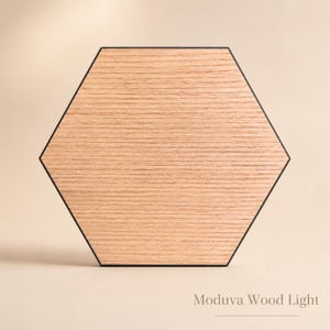 May include: Hexagonal wooden light fixture with a black border. The light has a natural wood grain pattern and the text "Moduva Wood Light" is at the bottom.