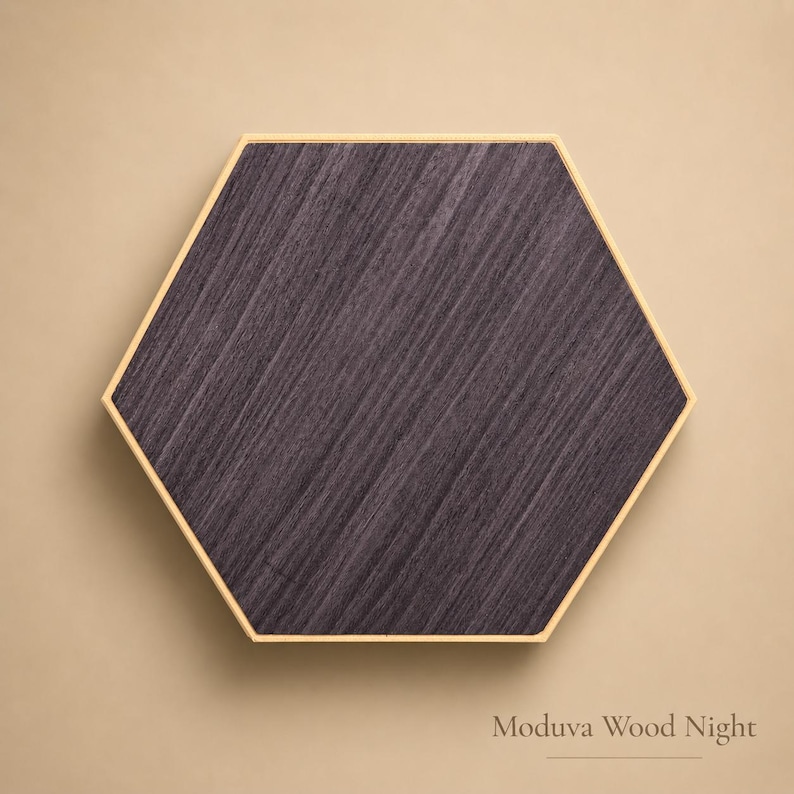 May include: A hexagonal wooden panel with a dark gray wood grain pattern. The panel is framed with a thin, light-colored border. The text "Moduva Wood Night" is at the bottom.