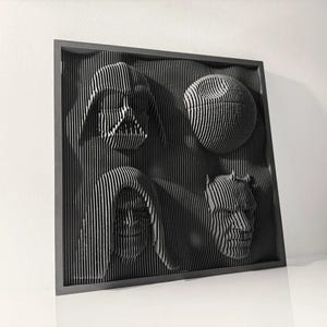 May include: A black framed wall art piece with a 3D design of four characters from Star Wars. The characters are Darth Vader, Princess Leia, Chewbacca, and a Death Star.