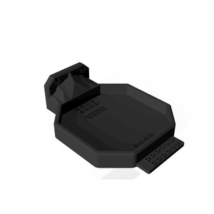 May include: A black, geometric-shaped product with a rectangular base and a raised, angled section. The product has a series of small, evenly spaced holes along one edge and the text "Rotor Riot" is visible.