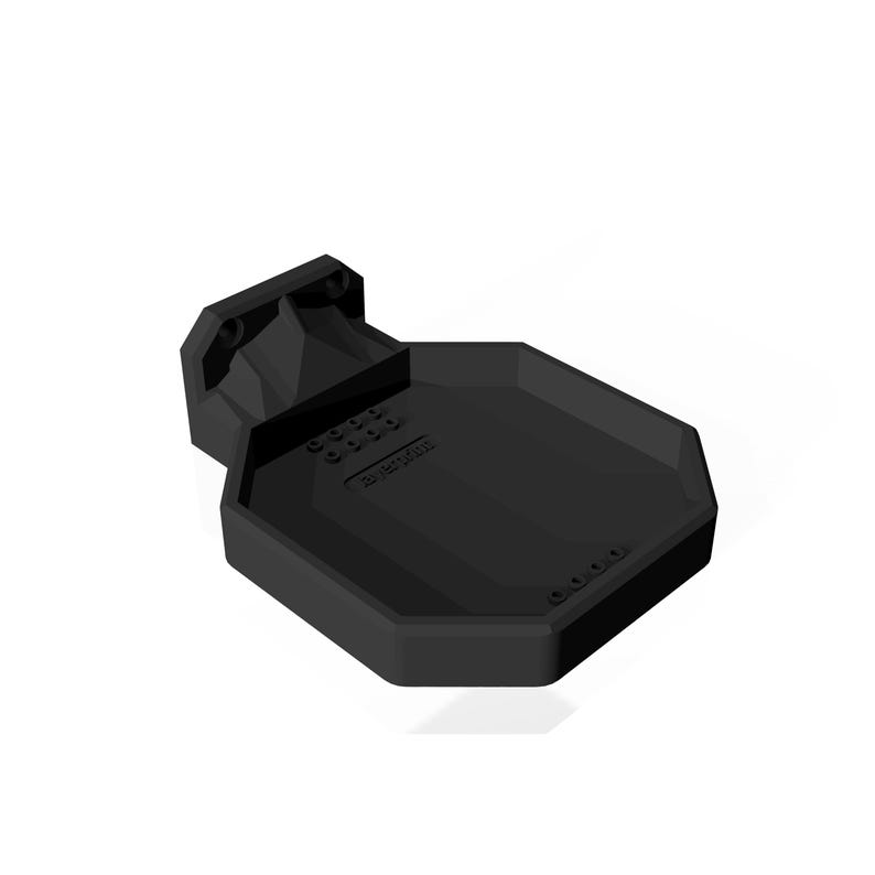 May include: A black, geometric-shaped product, possibly a shelf or holder, with a flat, octagonal surface and a mounting bracket. The product has a matte finish and appears to be made of plastic or a similar material. The text "Rotor Riot" is visible on the surface.