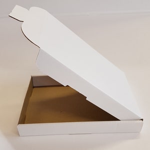 May include: White cardboard pizza box with a lid that is open. The box is empty.