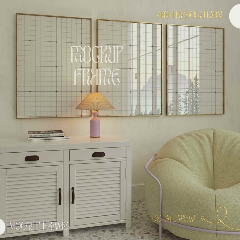May include: Three framed wall art pieces with a grid pattern hang above a white cabinet. A pink lamp with a pleated shade sits on the cabinet, next to a stack of books. A light green beanbag chair and a gold-framed mirror are also visible.