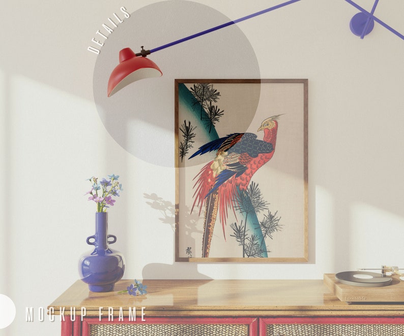 May include: A framed print of a colorful pheasant bird with a blue background. The print is hanging on a white wall above a wooden shelf with a vase of flowers and a record player.