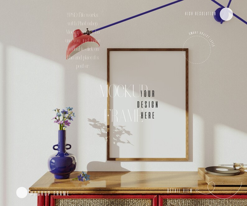 May include: A wooden frame mockup with a blank white space inside the frame. The frame is on a wooden table with a blue vase with flowers and a record player on the table. The text "MOCKUP YOUR DESIGN FRAME HERE" is written on the wall behind the frame.