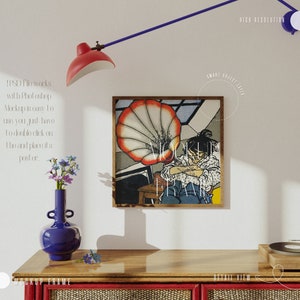 May include: A framed illustration of a person sitting in front of a large, red and white, vintage gramophone. The illustration is in a wooden frame with a white mat. The frame is hanging on a white wall.