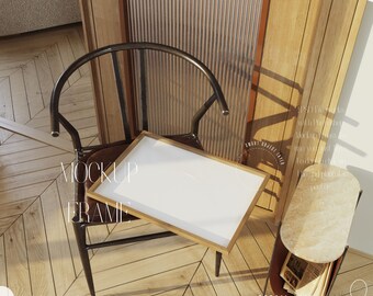 May include: A wooden frame mockup with a white background, sitting on a black metal chair with a brown leather seat. The chair is on a wooden floor with a herringbone pattern. The frame is tilted at an angle, and the background is blurred.
