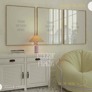 May include: A mockup scene featuring three gold-framed rectangular art prints with the text "YOUR DESIGN HERE". A white cabinet with a lamp and books sits below the frames. A light green beanbag chair is on the right.