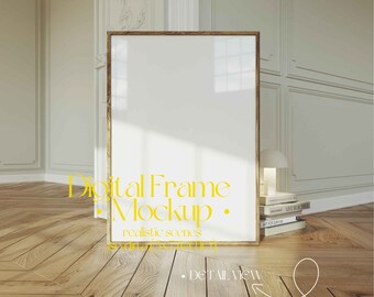May include: A digital frame mockup in a realistic setting. The frame is gold and is standing on a wooden floor with a stack of books and a lamp beside it. The background is a white wall with decorative molding.