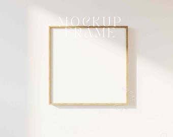 May include: A gold-colored frame mockup on a white wall. The frame is empty and ready for your design.