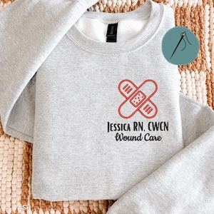 May include: A rustic wooden sign with the text "Welcome to our home" in white lettering. The sign features a distressed finish and a simple, inviting design, perfect for front door decor.