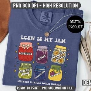 May include: A blue t-shirt with the text "LCSW IS MY JAM" and various jar illustrations. The jars contain words like "sessions," "trust," and "emotions." The shirt also includes the text "LICENSED CLINICAL SOCIAL WORKER."